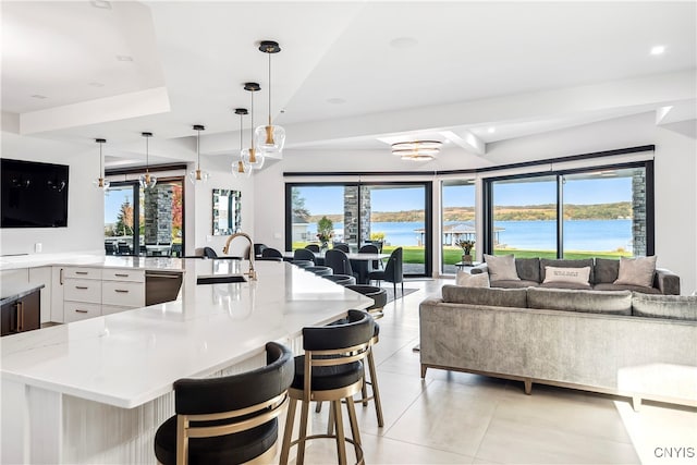 kitchen with a breakfast bar, plenty of natural light, and pendant lighting