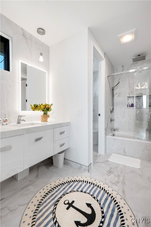 full bathroom with vanity, toilet, and tiled shower / bath combo