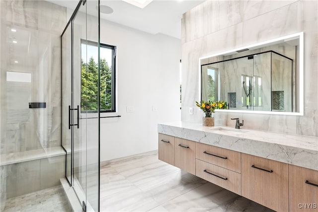 bathroom with vanity and a shower with shower door