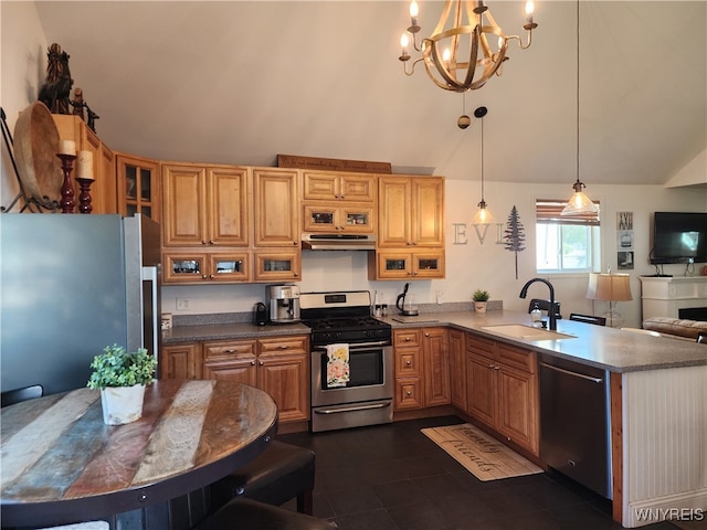 kitchen with appliances with stainless steel finishes, sink, dark tile patterned floors, hanging light fixtures, and a chandelier