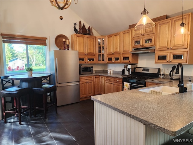 kitchen featuring kitchen peninsula, appliances with stainless steel finishes, high vaulted ceiling, pendant lighting, and sink