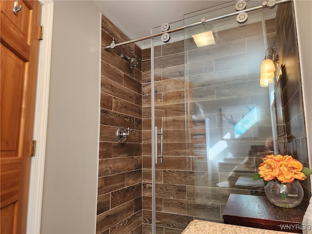 bathroom featuring vanity and a shower with shower door