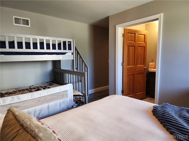 bedroom with dark hardwood / wood-style floors