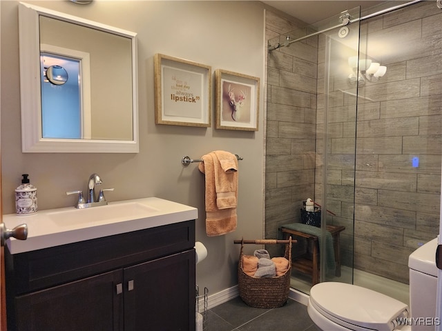 bathroom with vanity, tile patterned floors, toilet, and walk in shower