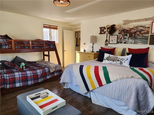 bedroom with dark hardwood / wood-style flooring