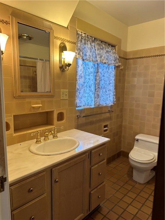 bathroom with tasteful backsplash, tile walls, toilet, vanity, and tile patterned flooring