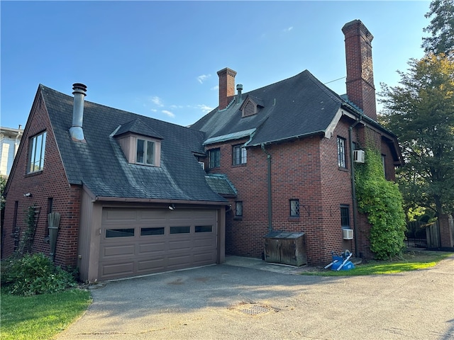 rear view of property featuring a garage