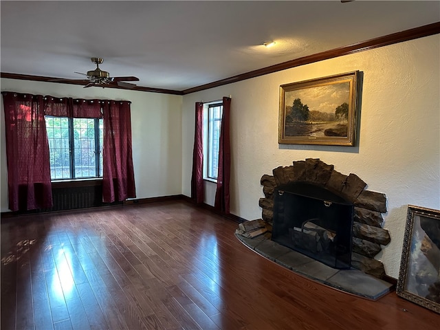 unfurnished living room featuring ceiling fan, ornamental molding, a wealth of natural light, and hardwood / wood-style floors