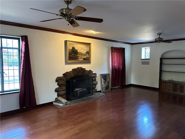 unfurnished living room with a healthy amount of sunlight, ornamental molding, and dark hardwood / wood-style floors