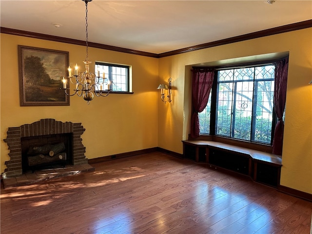 living room with crown molding, a fireplace, a notable chandelier, and dark hardwood / wood-style floors