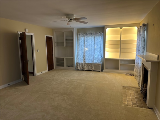 interior space featuring light carpet and ceiling fan