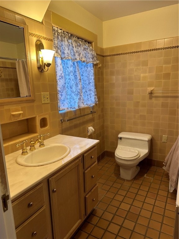 bathroom featuring vanity, toilet, tile walls, and tile patterned flooring