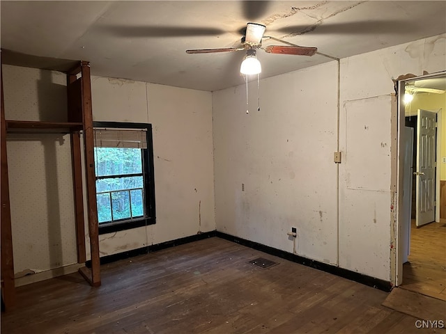 unfurnished bedroom with dark hardwood / wood-style floors and ceiling fan