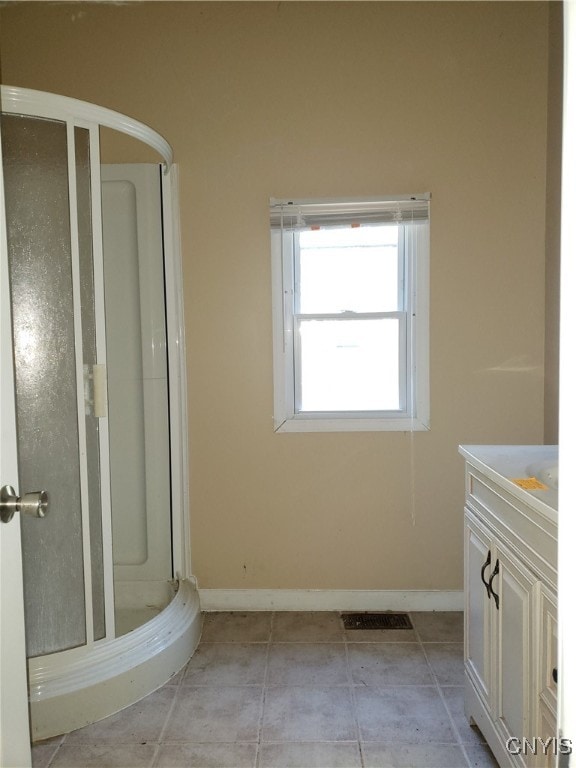 bathroom featuring vanity, tile patterned floors, and an enclosed shower