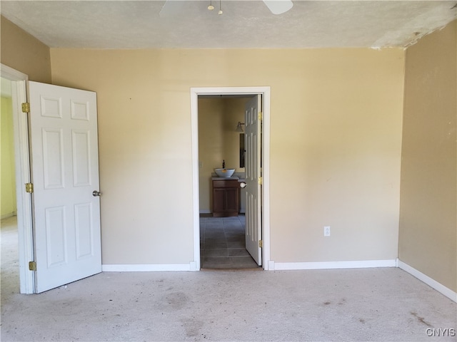 unfurnished bedroom featuring a textured ceiling and light colored carpet