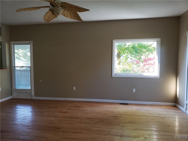 spare room with ceiling fan and light wood-type flooring