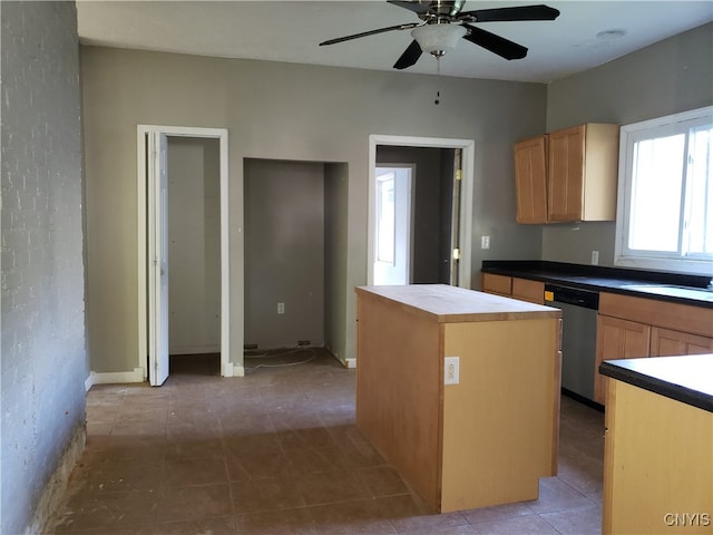 kitchen with a kitchen island, wood counters, ceiling fan, stainless steel dishwasher, and light brown cabinets