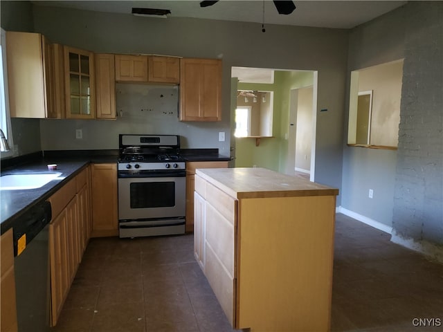 kitchen featuring dishwasher, range with gas stovetop, wood counters, sink, and a center island