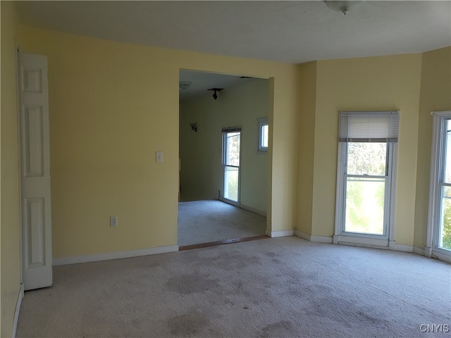 carpeted empty room with a wealth of natural light