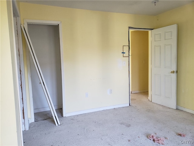 unfurnished bedroom featuring light carpet