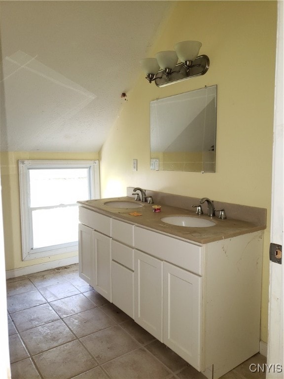 bathroom featuring vanity, lofted ceiling, and tile patterned floors