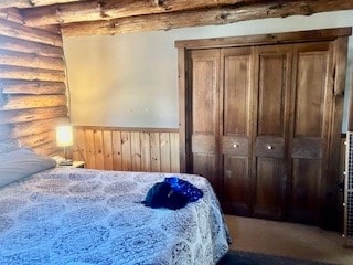 bedroom featuring log walls