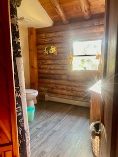 bathroom featuring wood ceiling, wood-type flooring, beamed ceiling, and log walls