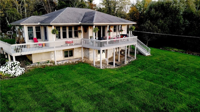 back of house featuring a deck and a lawn