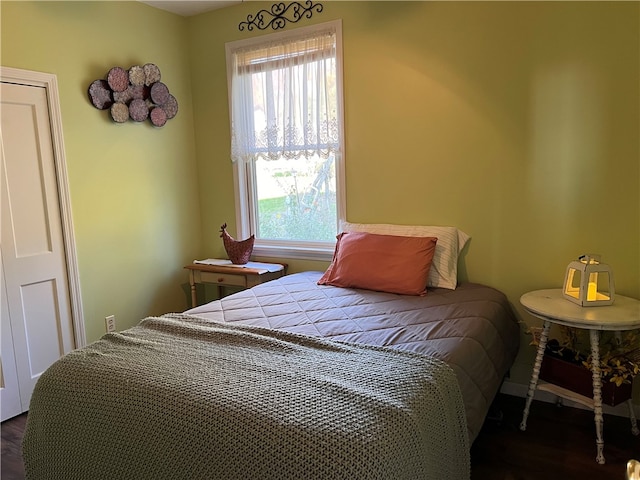 bedroom with dark hardwood / wood-style floors