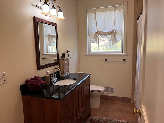 bathroom featuring vanity, a shower with curtain, toilet, and tile patterned flooring