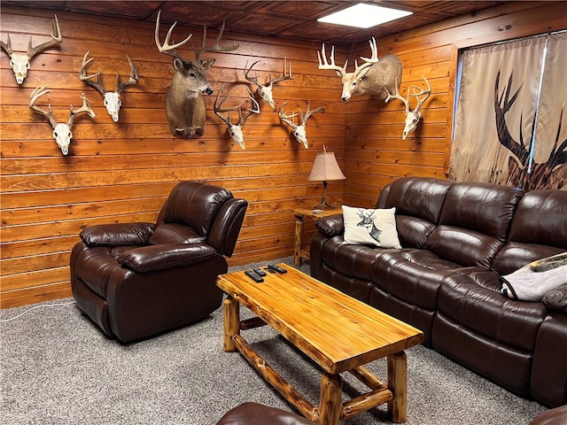 living room with carpet flooring and wood walls