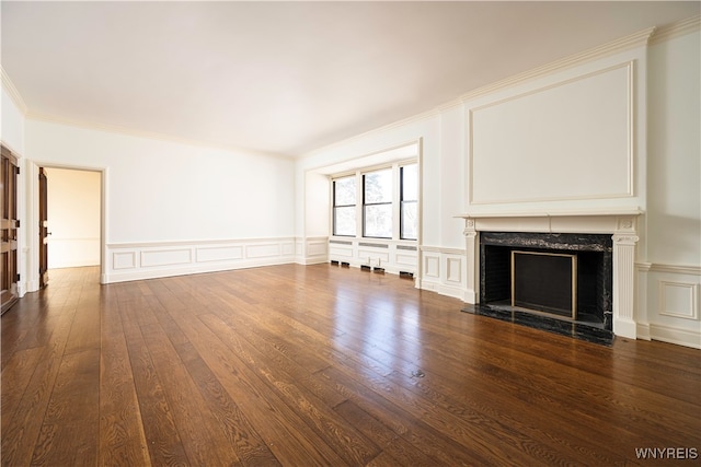 unfurnished living room with a high end fireplace, ornamental molding, and dark hardwood / wood-style floors