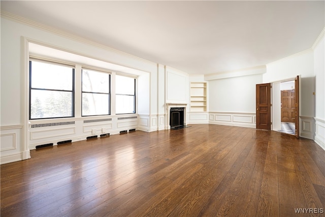 unfurnished living room featuring ornamental molding, dark wood-type flooring, and built in features