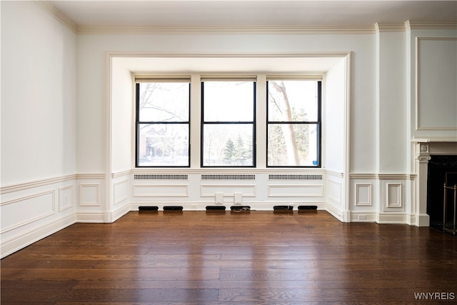 unfurnished living room with ornamental molding, dark hardwood / wood-style flooring, and plenty of natural light