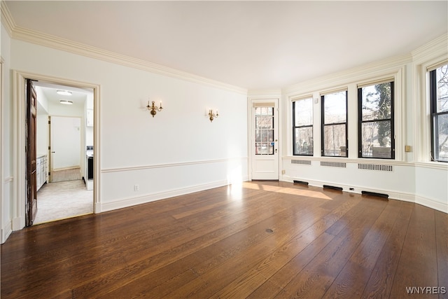 spare room with ornamental molding and hardwood / wood-style flooring