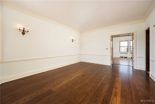 empty room with ornamental molding and dark hardwood / wood-style floors