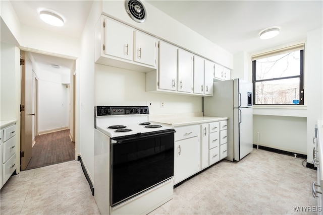 kitchen featuring white cabinetry and white appliances