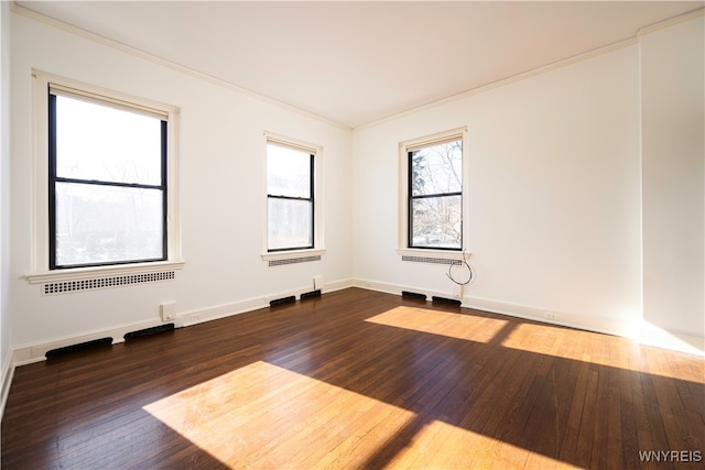 unfurnished room with dark wood-type flooring, ornamental molding, and radiator heating unit