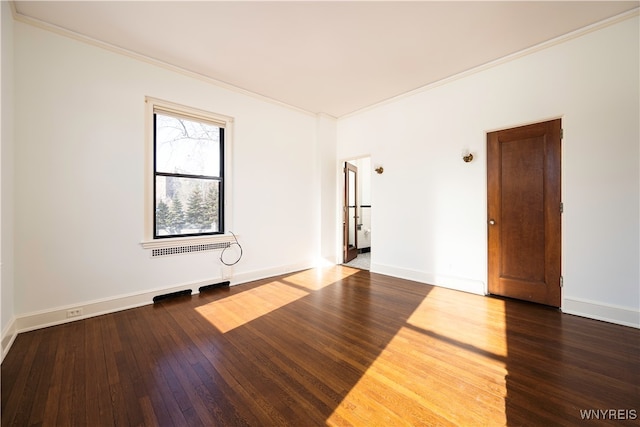 empty room with ornamental molding and hardwood / wood-style flooring