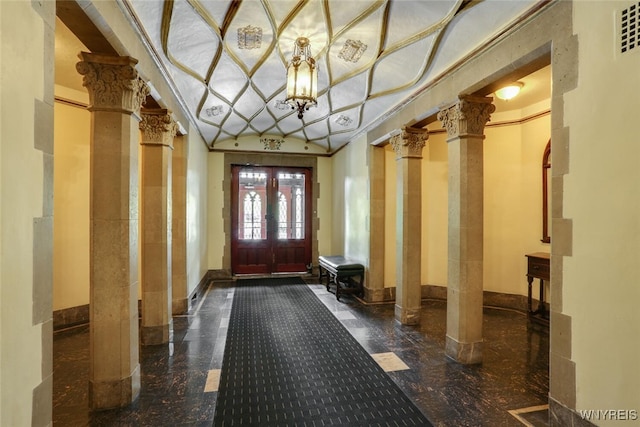 mudroom with decorative columns and crown molding