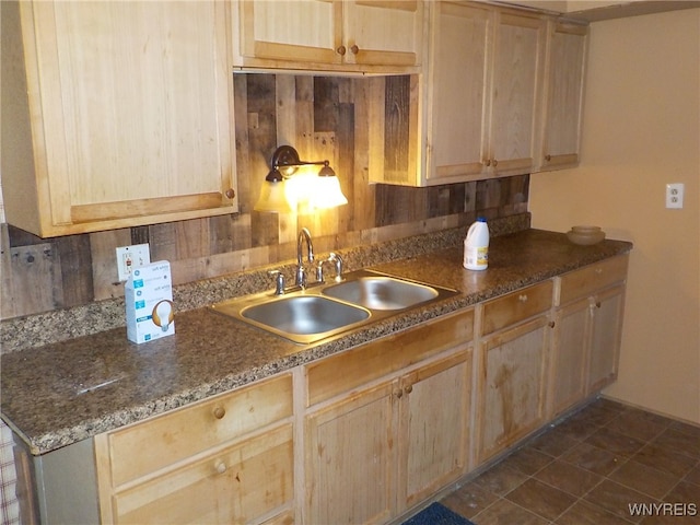 kitchen with light brown cabinetry and sink