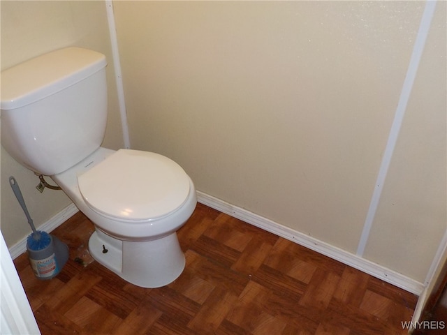 bathroom with parquet flooring and toilet