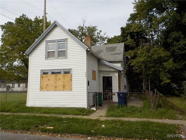 598 High St, Buffalo, NY 14211 - view of home's exterior with fence, a chimney, and a gate
