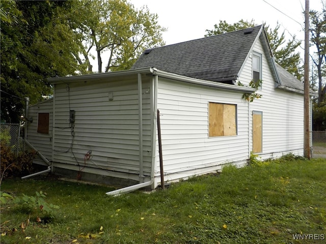 view of side of home with a yard