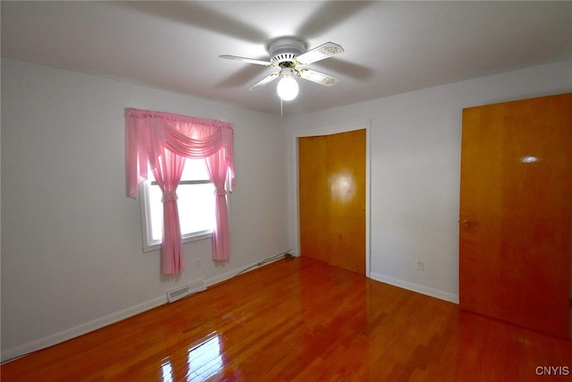 empty room featuring hardwood / wood-style floors and ceiling fan