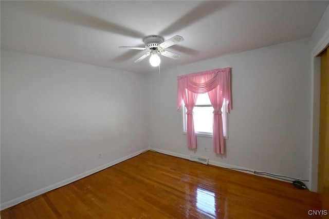 spare room with hardwood / wood-style flooring and ceiling fan