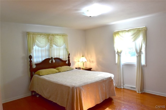 bedroom with wood-type flooring