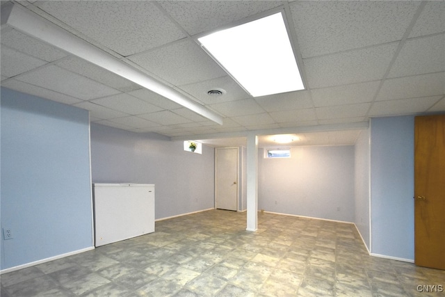 basement featuring a paneled ceiling