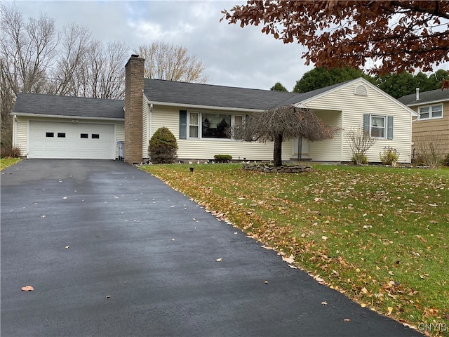 single story home with a garage and a front lawn