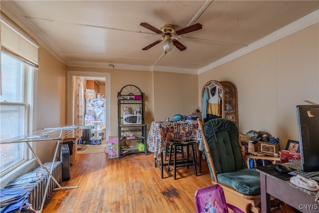 miscellaneous room featuring hardwood / wood-style floors, ceiling fan, crown molding, and plenty of natural light